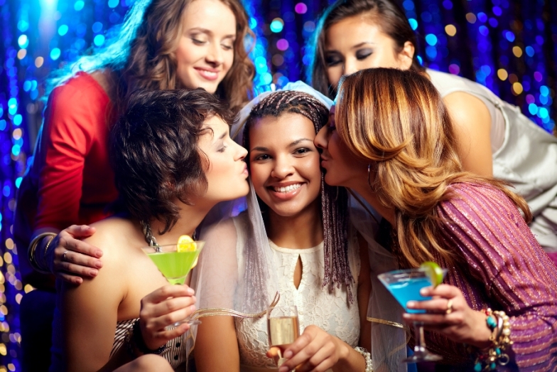 Beautiful female friends congratulating the bride and kissing her Beautiful female friends congratulating the bride and kissing her